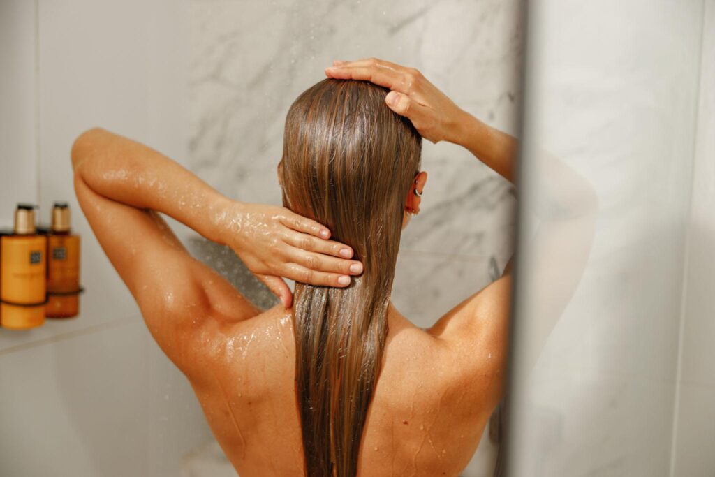 Woman applying natural conditioner as part of Ayurvedic hair care routine