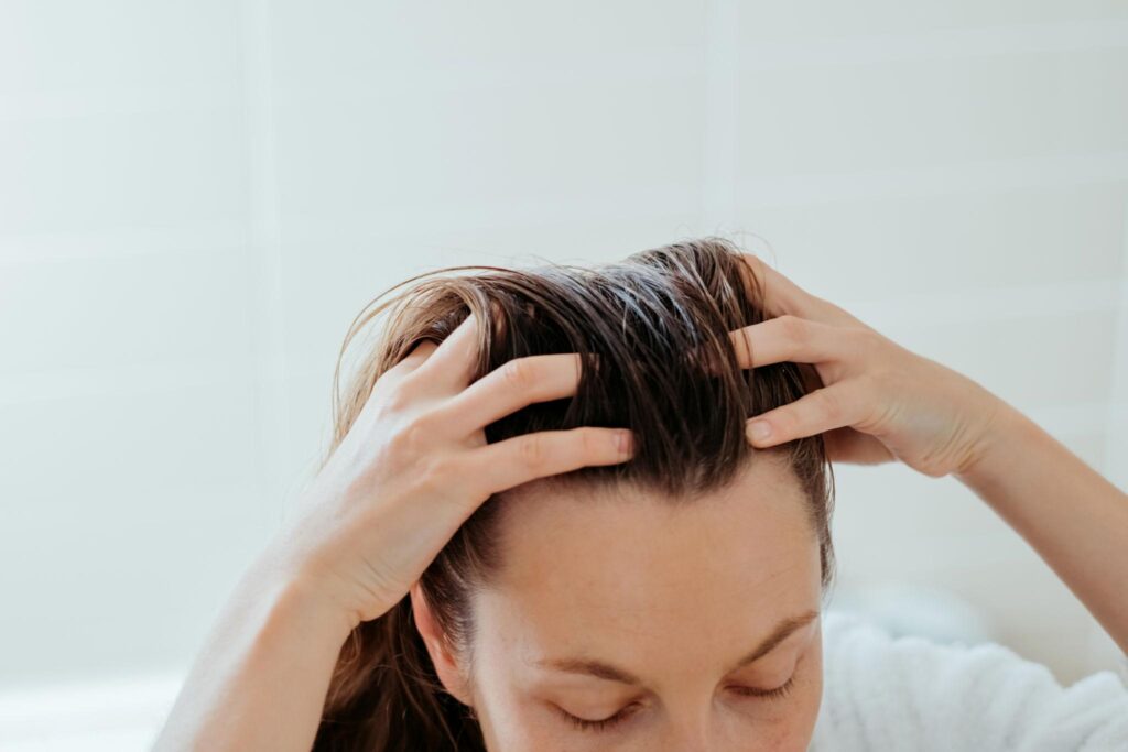 Natural hair oil scalp massage as part of Ayurvedic hair care routine