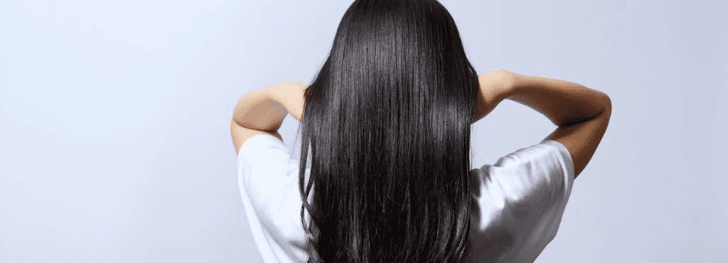 Woman with healthy shiny hair after natural Ayurvedic hair treatment
